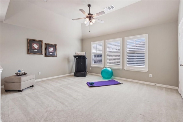 workout room featuring carpet floors, lofted ceiling, visible vents, and baseboards