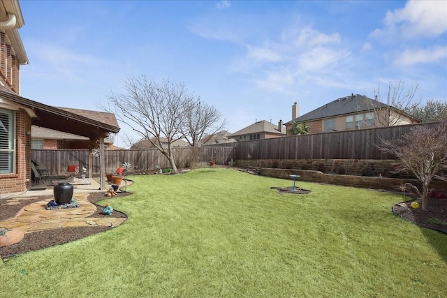 view of yard with a patio area and a fenced backyard