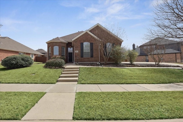 view of front of home with brick siding and a front lawn