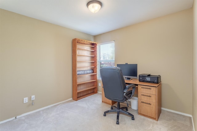 home office with baseboards and light colored carpet