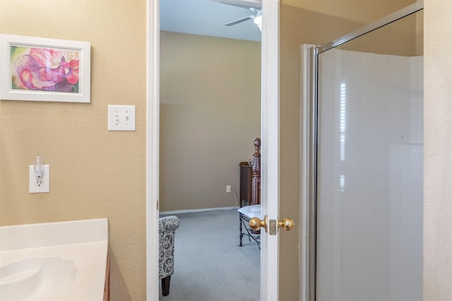 full bath featuring a stall shower and a ceiling fan