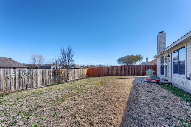 view of yard with a fenced backyard