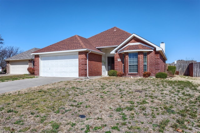 single story home featuring fence, driveway, an attached garage, a chimney, and brick siding