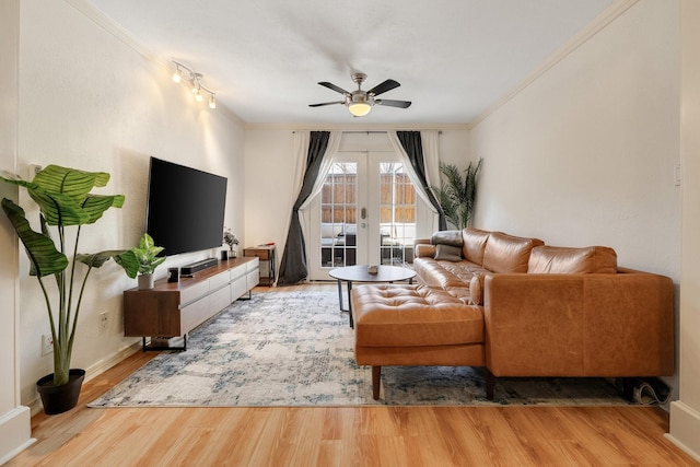 living room featuring ornamental molding, a ceiling fan, french doors, and wood finished floors