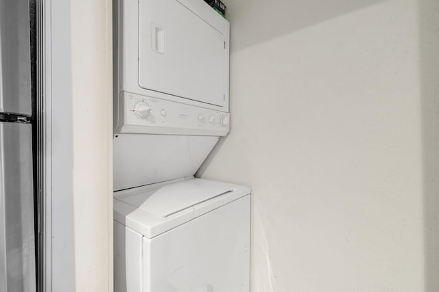 laundry room featuring stacked washing maching and dryer and laundry area