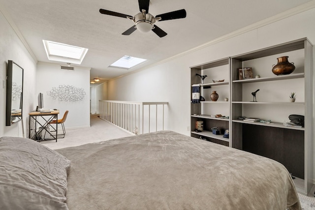 bedroom featuring carpet floors, visible vents, a ceiling fan, ornamental molding, and lofted ceiling with skylight