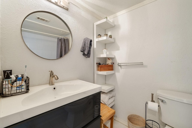 full bath featuring toilet, visible vents, and a sink