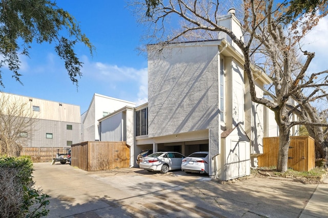 view of home's exterior featuring fence and stucco siding