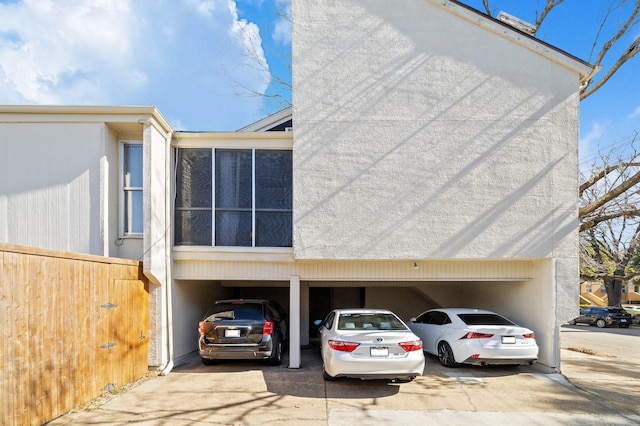 exterior space featuring a garage, driveway, and a carport