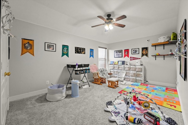 recreation room featuring ceiling fan, baseboards, and carpet flooring