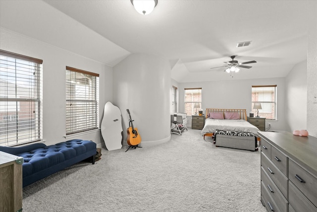 carpeted bedroom featuring lofted ceiling, baseboards, visible vents, and a ceiling fan