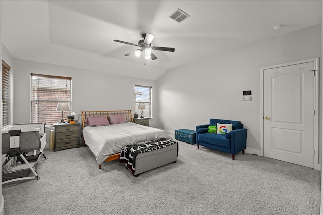 bedroom with lofted ceiling, a ceiling fan, visible vents, and light colored carpet