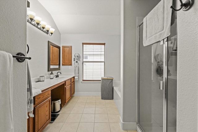 bathroom featuring tile patterned flooring, vaulted ceiling, a shower stall, and vanity