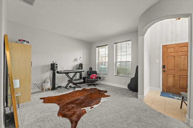 workout room with arched walkways, tile patterned flooring, carpet flooring, visible vents, and baseboards