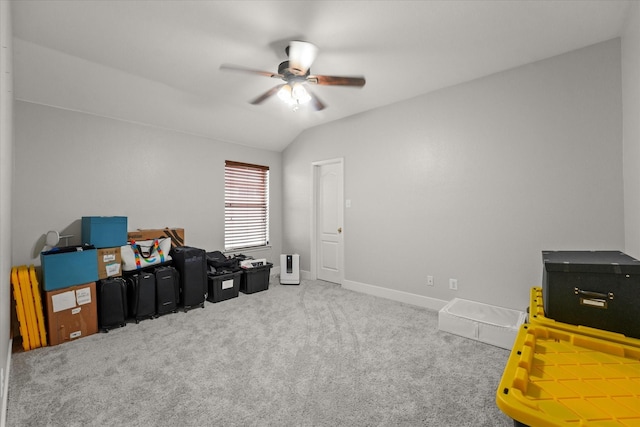 interior space with lofted ceiling, carpet, baseboards, and ceiling fan