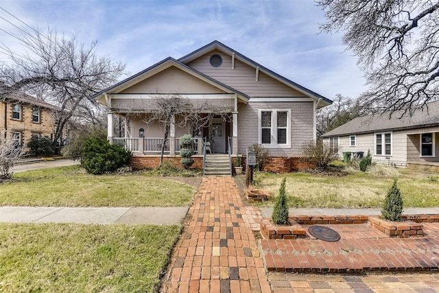 bungalow-style home with a porch and a front yard