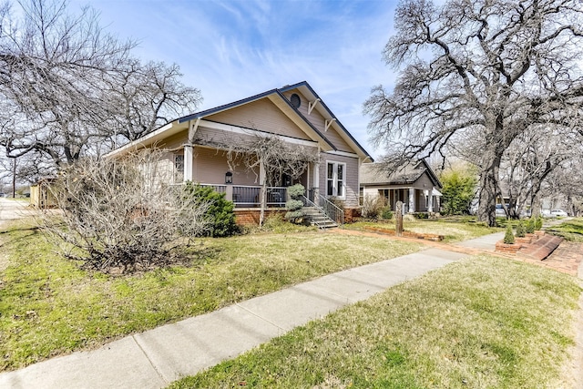 bungalow featuring a porch and a front yard