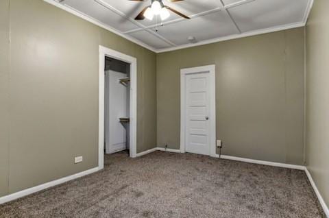 unfurnished bedroom featuring crown molding, baseboards, and carpet flooring