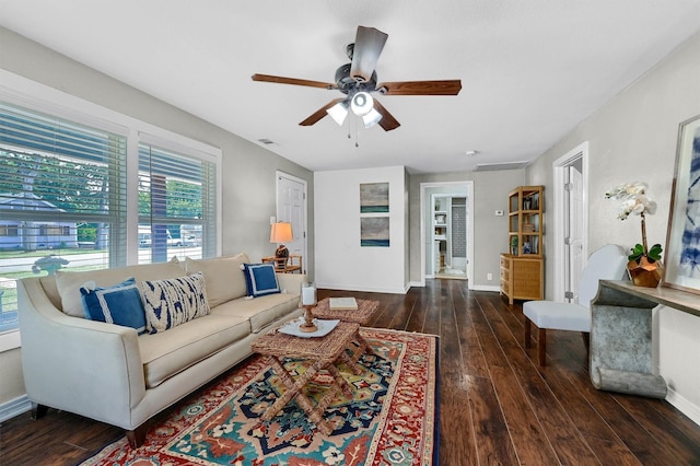 living room featuring a ceiling fan, wood-type flooring, visible vents, and baseboards