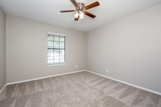 spare room with carpet floors, baseboards, and a ceiling fan