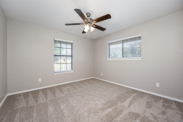 empty room with a ceiling fan, carpet flooring, and baseboards