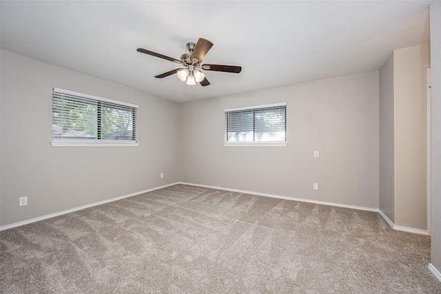 spare room featuring carpet floors, baseboards, and a ceiling fan