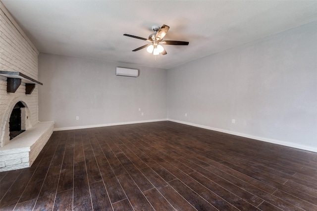 unfurnished living room with ceiling fan, a fireplace, wood finished floors, and a wall mounted air conditioner