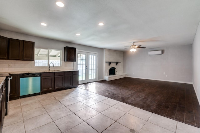 kitchen with a brick fireplace, dishwasher, a sink, and dark brown cabinets