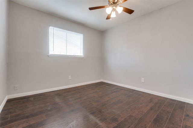 unfurnished room with dark wood-style floors, a ceiling fan, and baseboards