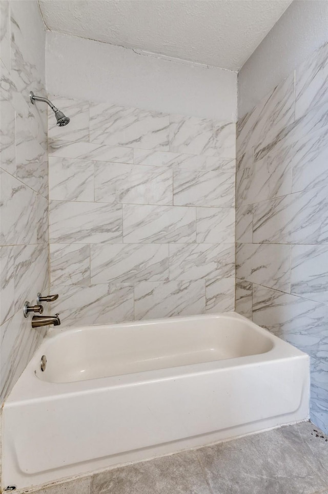 bathroom featuring a textured ceiling and shower / bath combination