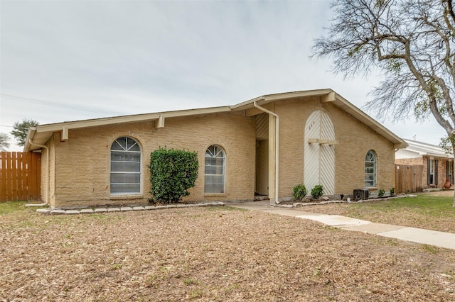 view of front of property with fence and stucco siding