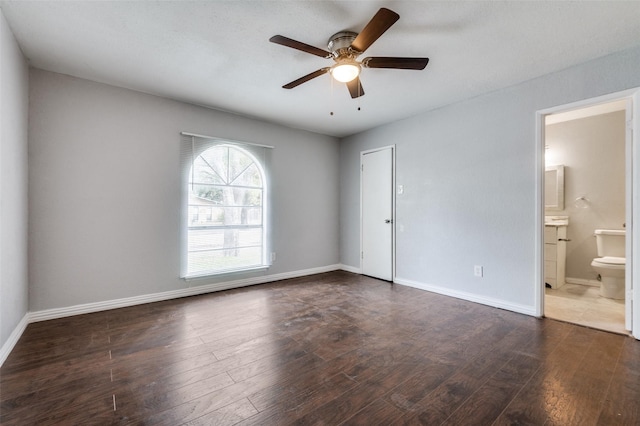 unfurnished room with a ceiling fan, wood-type flooring, and baseboards