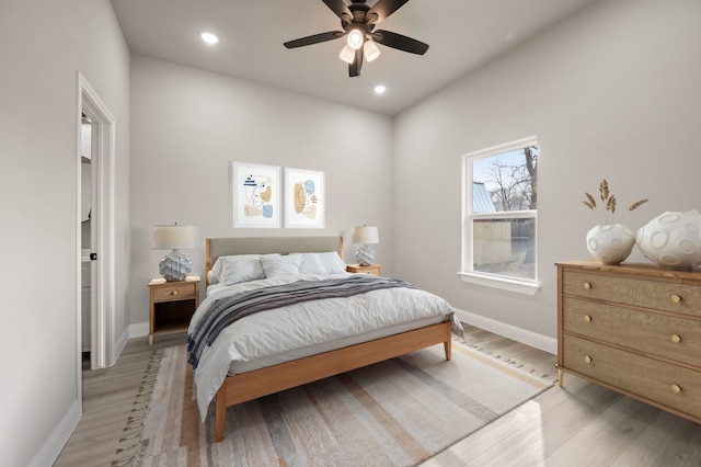 bedroom with light wood-style floors, recessed lighting, and baseboards