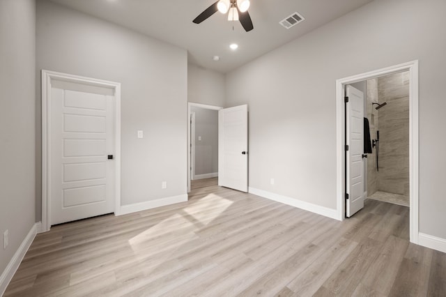 unfurnished bedroom with light wood-style floors, visible vents, baseboards, and ensuite bathroom