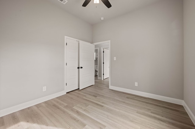 unfurnished room with baseboards, ceiling fan, visible vents, and light wood-style floors