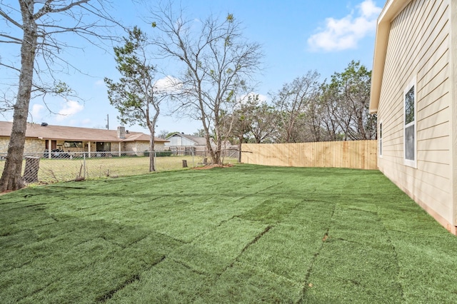 view of yard with a fenced backyard