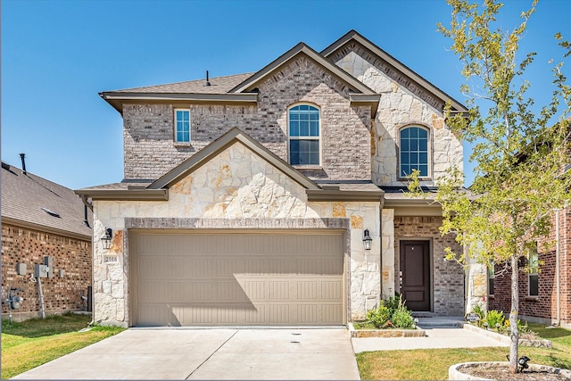 french country inspired facade featuring driveway, brick siding, roof with shingles, and stone siding