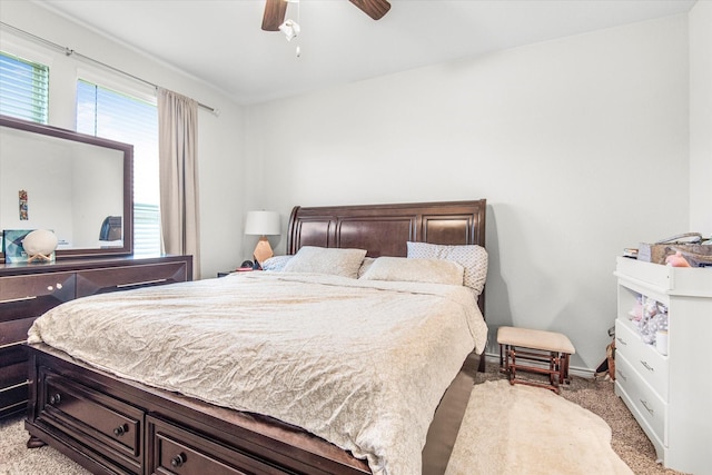 bedroom with baseboards, multiple windows, a ceiling fan, and carpet flooring