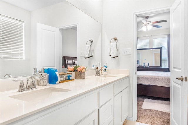 full bath featuring a sink, double vanity, ensuite bath, and a ceiling fan