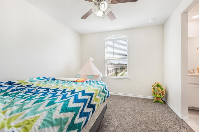 bedroom with a ceiling fan, baseboards, a sink, and light colored carpet