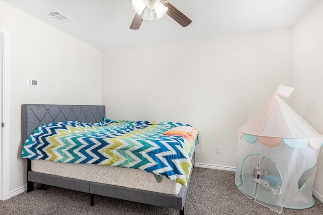 carpeted bedroom featuring a ceiling fan, visible vents, and baseboards