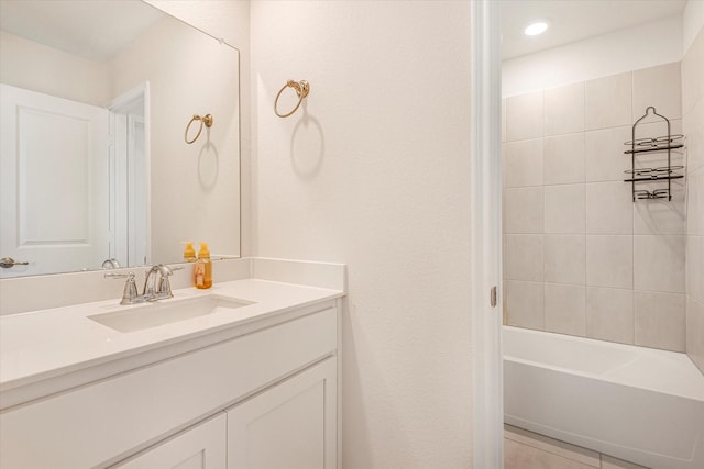 bathroom featuring tub / shower combination, vanity, and tile patterned floors