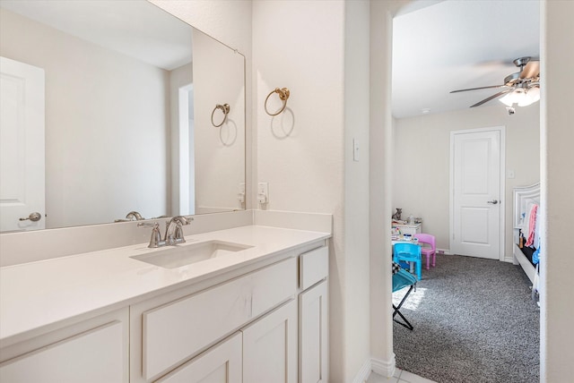 bathroom featuring connected bathroom, vanity, baseboards, and ceiling fan