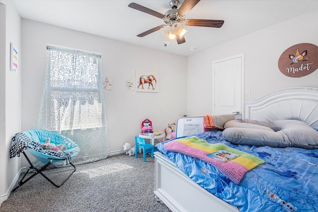 bedroom with ceiling fan, baseboards, and carpet flooring