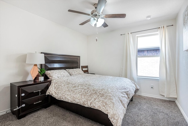 bedroom with ceiling fan, carpet flooring, and baseboards