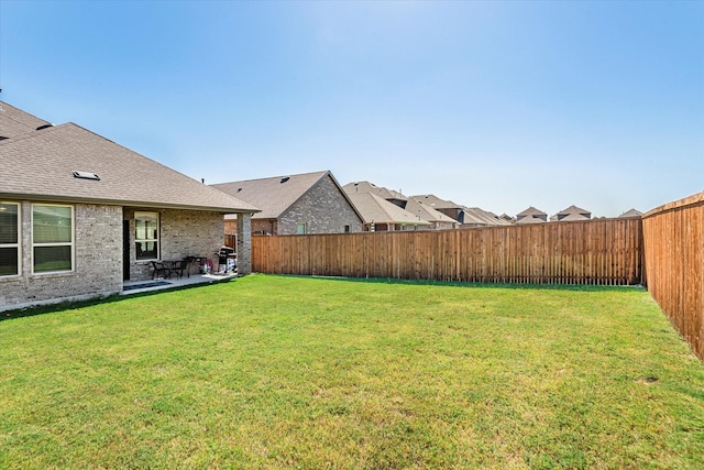 view of yard with a fenced backyard and a patio