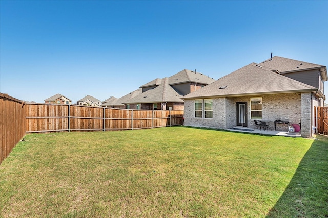 view of yard featuring a patio area and a fenced backyard