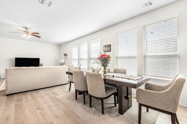 dining area featuring ceiling fan, light wood-type flooring, and visible vents