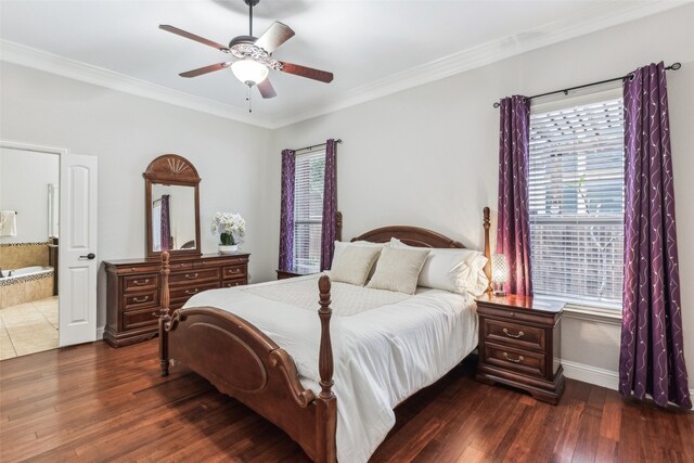 bedroom featuring crown molding, dark wood-style floors, baseboards, and ensuite bathroom