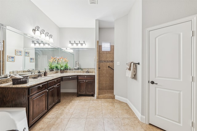 bathroom with tile patterned floors, vanity, and walk in shower